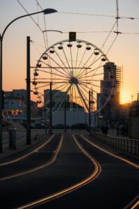 A ferris wheel at sunset on a street