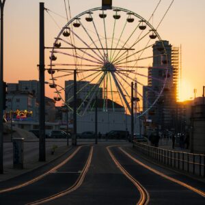 A ferris wheel at sunset on a street