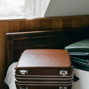 Suitcases placed on edge of bed